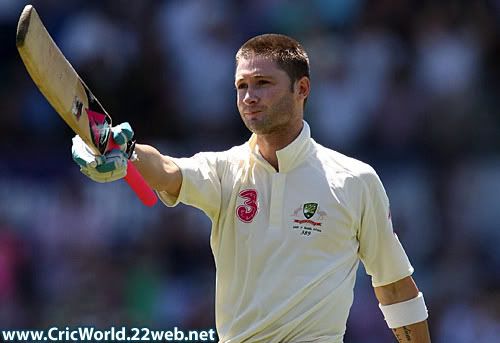 Michael Clarke raises his bat after reaching his first hundred on his home ground