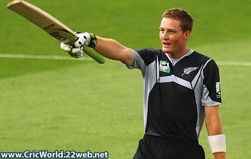 Martin Guptill raises his bat after reaching a century on debut